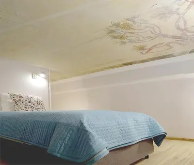 a bedroom with a bed with a painting on the ceiling at Art Apartments w centrum Krakowa (Śródmieście, Stradom) in Kraków