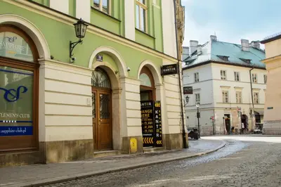 an empty street in a city with buildings at Mikołajska Apartments with Lift in Kraków