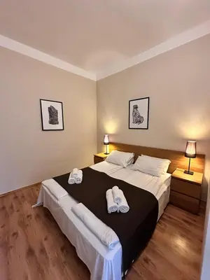 a bedroom with a large bed with towels on it at Mikołajska Apartments with Lift in Kraków