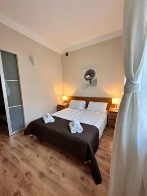 a bedroom with a bed with two towels on it at Mikołajska Apartments with Lift in Kraków