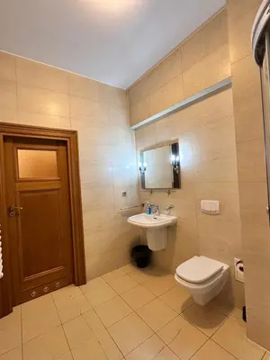 a bathroom with a toilet and a sink at Mikołajska Apartments with Lift in Kraków