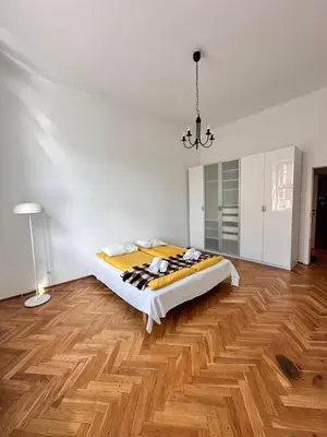 a bedroom with a bed and a wooden floor at Small Market Square - Old Town in Kraków