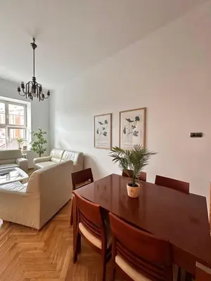 a living room with a table and a couch at Small Market Square - Old Town in Kraków