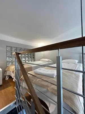two bunk beds in a room with a balcony at Small Market Square - Old Town in Kraków
