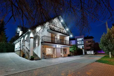 a large white building with lights on it at Noclegi u Nawary in Rabka