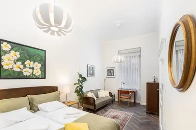a living room with a bed and a mirror at Otium Old Town Sarego in Kraków