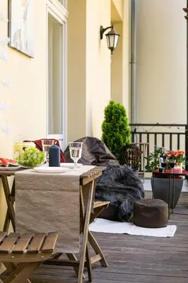 a table with a glass of wine on a patio at Otium Old Town Sarego in Kraków