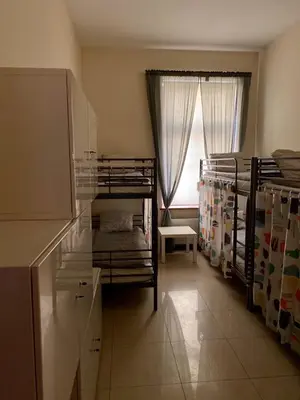 a room with two bunk beds and a window at Ametyst Hostel in Kraków
