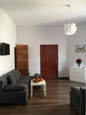 a living room with a couch and a table at Ametyst Hostel in Kraków