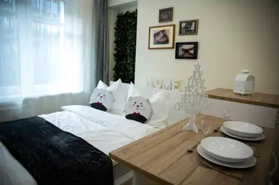 a bedroom with a bed with two cats on it at Amazing Apartment, City Centre, Modern, Elegant, Cozy in Kraków