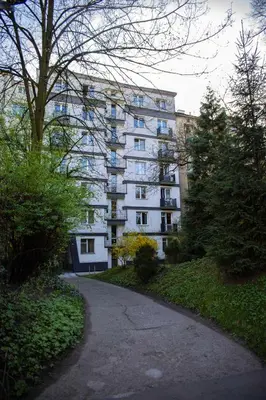 a large white building with a path in front of it at Amazing Apartment, City Centre, Modern, Elegant, Cozy in Kraków