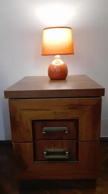 a lamp sitting on top of a dresser with a drawer at Studio Krakowski Styl in Kraków