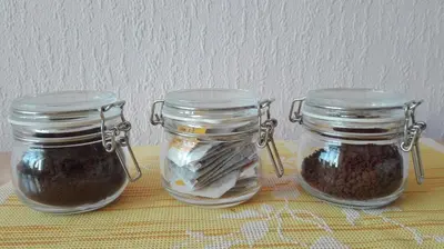 three glass jars filled with food on a table at Studio Krakowski Styl in Kraków