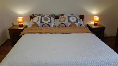 a large bed with two lamps on two tables at Studio Krakowski Styl in Kraków