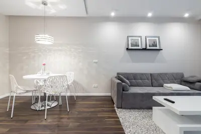 a living room with a couch and a table at Glossy Apart W19 in Kraków