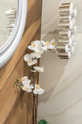 a white flower floor lamp in front of a mirror at Glossy Apart W19 in Kraków