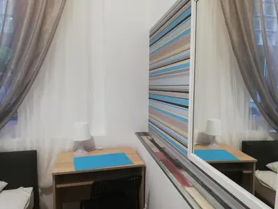 a mirror in a room with two tables and chairs at Lorf Hostel&Coffee in Kraków