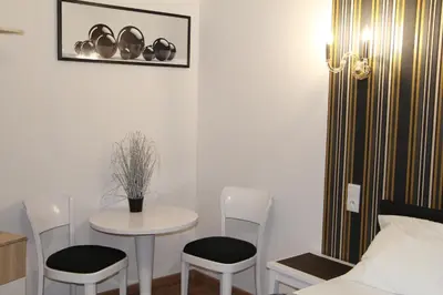 a room with a table and chairs and a bed at Lorf Hostel&Coffee in Kraków
