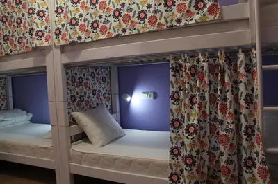 a bedroom with two bunk beds with curtains at Lorf Hostel&Coffee in Kraków