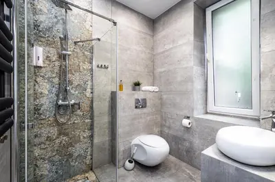 a bathroom with a shower and a toilet and a sink at RentPlanet - Studio Krasińskiego in Kraków