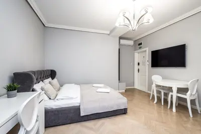 a living room with a couch and a table at RentPlanet - Studio Krasińskiego in Kraków