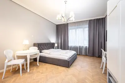 a bedroom with a bed and a table and chairs at RentPlanet - Studio Krasińskiego in Kraków