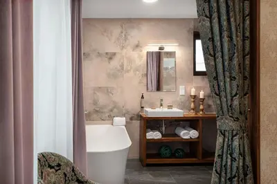a bathroom with a tub and a sink at Hotel Zameczek in Książ Wielki
