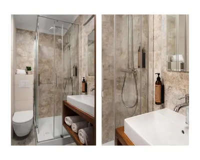 a bathroom with a shower and a sink and a toilet at Hotel Zameczek in Książ Wielki