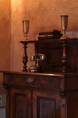 a wooden table with a telephone on top of it at Hotel Zameczek in Książ Wielki