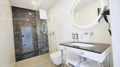a bathroom with a sink and a shower at SZEWSKA 22 BOUTIQUE in Kraków