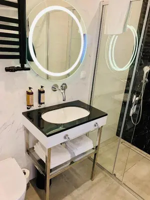 a bathroom with a sink and a mirror at SZEWSKA 22 BOUTIQUE in Kraków