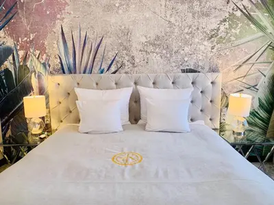 a bedroom with a white bed with two pillows at SZEWSKA 22 BOUTIQUE in Kraków