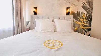 a white bed with a peace sign on it at SZEWSKA 22 BOUTIQUE in Kraków