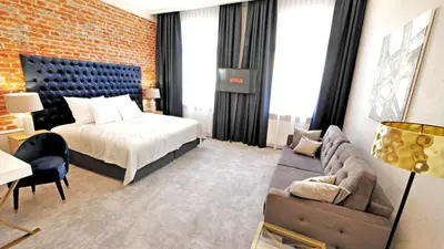 a hotel room with a bed and a couch at SZEWSKA 22 BOUTIQUE in Kraków