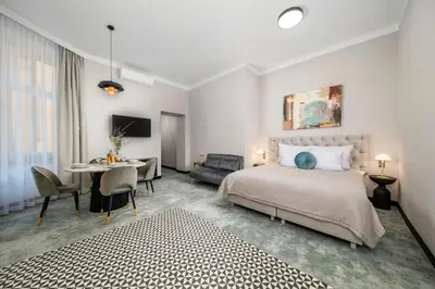 a bedroom with a bed and a table and a desk at SZEWSKA 22 BOUTIQUE in Kraków