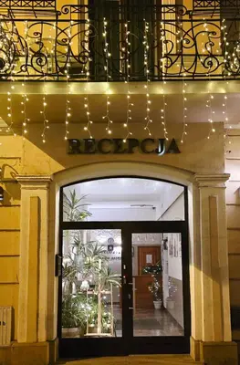 a door to a store with a sign above it at Apartamenty Kajzer in Kraków