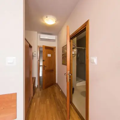 a hallway with a door and a room with a hallway at Apartamenty Kajzer in Kraków