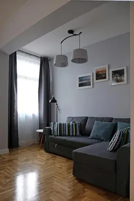a living room with a couch and a window at Grey Apartments Kościuszko in Kraków