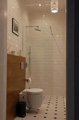 a bathroom with a toilet and a glass shower at Grey Apartments Kościuszko in Kraków