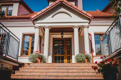 a house with stairs in front of it at Pod Kolumnami in Pilica