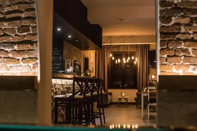 a bar in a restaurant with chairs and a table at Pod Kolumnami in Pilica