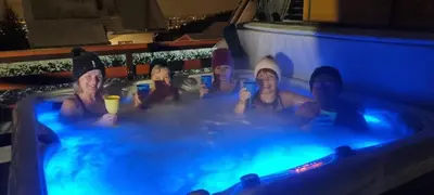 a group of people in a hot tub at a resort at Noclegi Na Bukowym Stoku in Czaniec