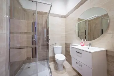 a bathroom with a shower and a sink and a toilet at 70s Hostel in Kraków