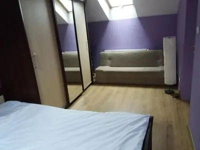 a bedroom with a bed and a mirror and a couch at U Adama in Wieliczka