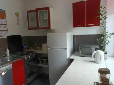 a kitchen with a white refrigerator and a microwave at U Adama in Wieliczka