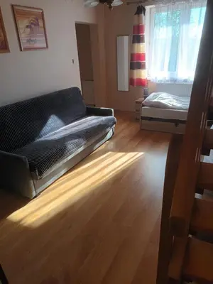 a living room with a couch and a bed at U Adama in Wieliczka