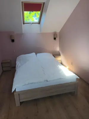 a bed in a small room with a window at U Adama in Wieliczka