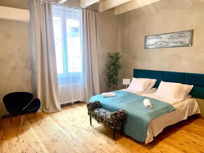 a bedroom with a blue bed and a window at Florianska Deluxe Apartments with Air Condition in Kraków