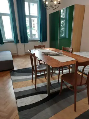 a dining room with a wooden table and chairs at Apartment Mariacki Tower in Kraków