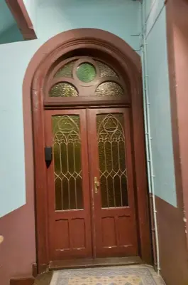a wooden door with a window on a building at Apartment Mariacki Tower in Kraków